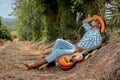 An African Xhosa Cowboy relaxing on a country road in South Africa with his guitar. Royalty Free Stock Photo