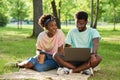 Young people sitting in the park Royalty Free Stock Photo