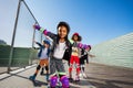 African girl rollerblading with friends outdoors