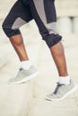 African young man athlete steps up with energy in bleachers Royalty Free Stock Photo