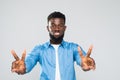 African young man happy expression and peace gesture isolated on gray background Royalty Free Stock Photo