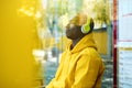 African Young Man Listening To Music At Bus Stop Royalty Free Stock Photo