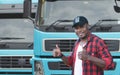 African Young Man owner Truck Driver happy Smiling confident near lorry Royalty Free Stock Photo