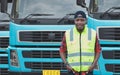 African Young Man owner Truck Driver happy Smiling confident near lorry Royalty Free Stock Photo
