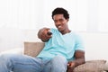 African young man watching television Royalty Free Stock Photo