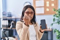 African young woman holding smartphone showing blank screen annoyed and frustrated shouting with anger, yelling crazy with anger Royalty Free Stock Photo