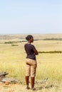 African young woman looking at the savanna in Africa