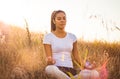 African young woman in nature sitting in yoga position lYoga