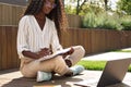 African young woman student learning using laptop studying outside campus. Royalty Free Stock Photo