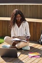 African young woman student writing notes elearning using laptop outdoors. Royalty Free Stock Photo