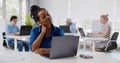 African young woman suffering with pain massaging neck while working in office Royalty Free Stock Photo