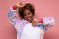 African young woman wearing colorful pyjamas having fun smiling, stretching hands. Royalty Free Stock Photo