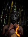 A young African wearing a mask