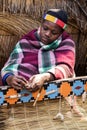 African Zulu woman weaves straw carpet. Royalty Free Stock Photo