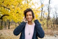 Africanamerican girl listening to music in the autumn park Royalty Free Stock Photo