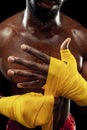 Afro American boxer is wrapping hands with bandage