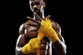 Afro American boxer is wrapping hands with bandage