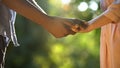 Afro-American boy taking girlfriends hand at sunny park, trustful relations