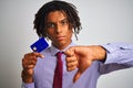 Afro american businessman with dreadlocks holding credit card over isolated white background with angry face, negative sign Royalty Free Stock Photo