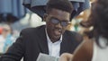 Afro-american businessman with his colleague reading menu in restaurant Royalty Free Stock Photo