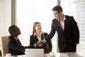 Afro american and caucasian cheerful businessmen handshaking at Royalty Free Stock Photo