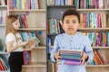 Afro american child boy choosing books in school library. Benefits of everyday reading Royalty Free Stock Photo