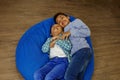 Afro american children playing and having fun on bean bag chair. Break time. Meeting friends Royalty Free Stock Photo