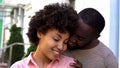 Afro-american couple enjoying date, girl feeling safe in boyfriend arms, smiling Royalty Free Stock Photo