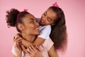 Afro American daughter and mother in sham crowns