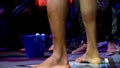 Afro american fighter preparing for fight, view on his legs close up. Young afro american sportsman resting after