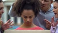 Afro-american girl suffering people screaming racial insults, bullying problem