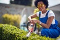 Afro-American Green Thumb Trimming Hedges with Grace and Precision Royalty Free Stock Photo