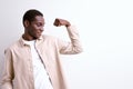 afro american guy showing arm muscles, powerful strong man isolated on white Royalty Free Stock Photo