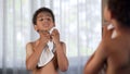 Afro-American kid doing morning hygiene, healthy lifestyle, wiping by towel