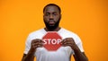 Afro-American man showing stop sign, male against racial discrimination, closeup Royalty Free Stock Photo