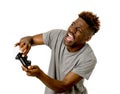 Afro american man using remote controller playing video game happy and excited Royalty Free Stock Photo