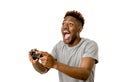 Afro american man using remote controller playing video game happy and excited Royalty Free Stock Photo