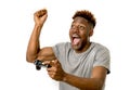 Afro american man using remote controller playing video game happy and excited Royalty Free Stock Photo