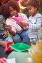 Afro-american mother teaching daughter how to make paper boat. Family value, togetherness, teaching concept