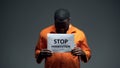 Afro-american prisoner holding stop persecution sign, racial discrimination