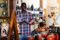 Afro-american seller offers handmade pottery in the store