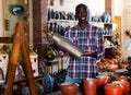 Afro-american seller offers handmade pottery in the store