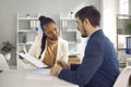 Afro american solicitor pointing at insurance contract showing client to sign Royalty Free Stock Photo