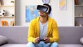 Afro-American teenage boy playing video game in VR headset, modern technologies Royalty Free Stock Photo