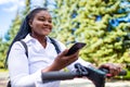 afro american woman activate and prepay a rental e-scooter or an e-bicycle on the street Royalty Free Stock Photo