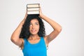 Afro american woman holding books on the head Royalty Free Stock Photo