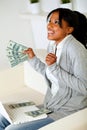 Afro-american woman looking up with dollars Royalty Free Stock Photo