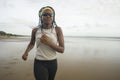 Afro American woman running on the beach - young attractive and athletic black girl training outdoors doing jogging workout at the Royalty Free Stock Photo