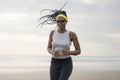 Afro American woman running on the beach - young attractive and athletic black girl training outdoors doing jogging workout at the Royalty Free Stock Photo