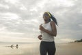 Afro American woman running on the beach - young attractive and athletic black girl training outdoors doing jogging workout at the Royalty Free Stock Photo